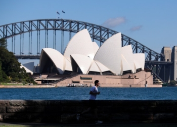 A man runs in a park opposite the Sydney Opera House in Sydney, Australia, on Feb. 26, 2021.(Photo: Xinhua)