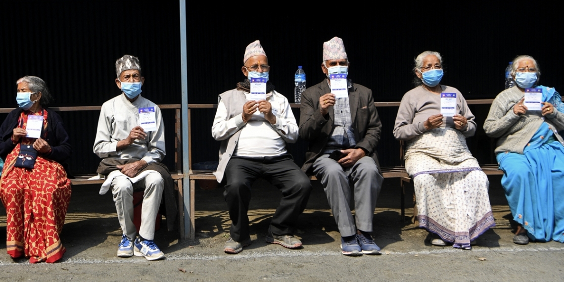 People display their cards after getting the coronavirus vaccine on the outskirts of Kathmandu, Nepal, on Sunday. Nepal will administer the second dose of the COVID-19 vaccine from April 20 to April 28 to those who have received the first shot of the vaccine from January 27 to February 12. The first dose of the COVID-19 vaccine was given to health professionals, security personnel, officials of diplomatic missions, embassies, and those working in the United Nations. Photo: AFP