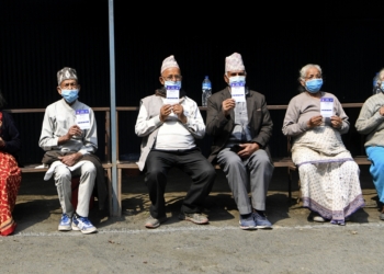 People display their cards after getting the coronavirus vaccine on the outskirts of Kathmandu, Nepal, on Sunday. Nepal will administer the second dose of the COVID-19 vaccine from April 20 to April 28 to those who have received the first shot of the vaccine from January 27 to February 12. The first dose of the COVID-19 vaccine was given to health professionals, security personnel, officials of diplomatic missions, embassies, and those working in the United Nations. Photo: AFP