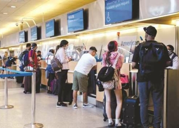 Travellers at an American Airlines check-in counter at Philadelphia International Airport (PHL) in P