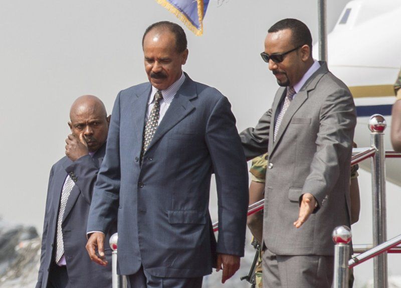 Eritrean President Isaias Afwerkii is welcomed by Ethiopia's Prime Minister Abiy Ahmed upon his arrival at Addis Ababa International Airport