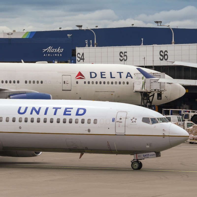 delta and united airlines airplane next to each other at airport