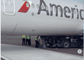Tug and driver get stuck underneath American Airlines Boeing 737 800 - Travel News, Insights & Resources.