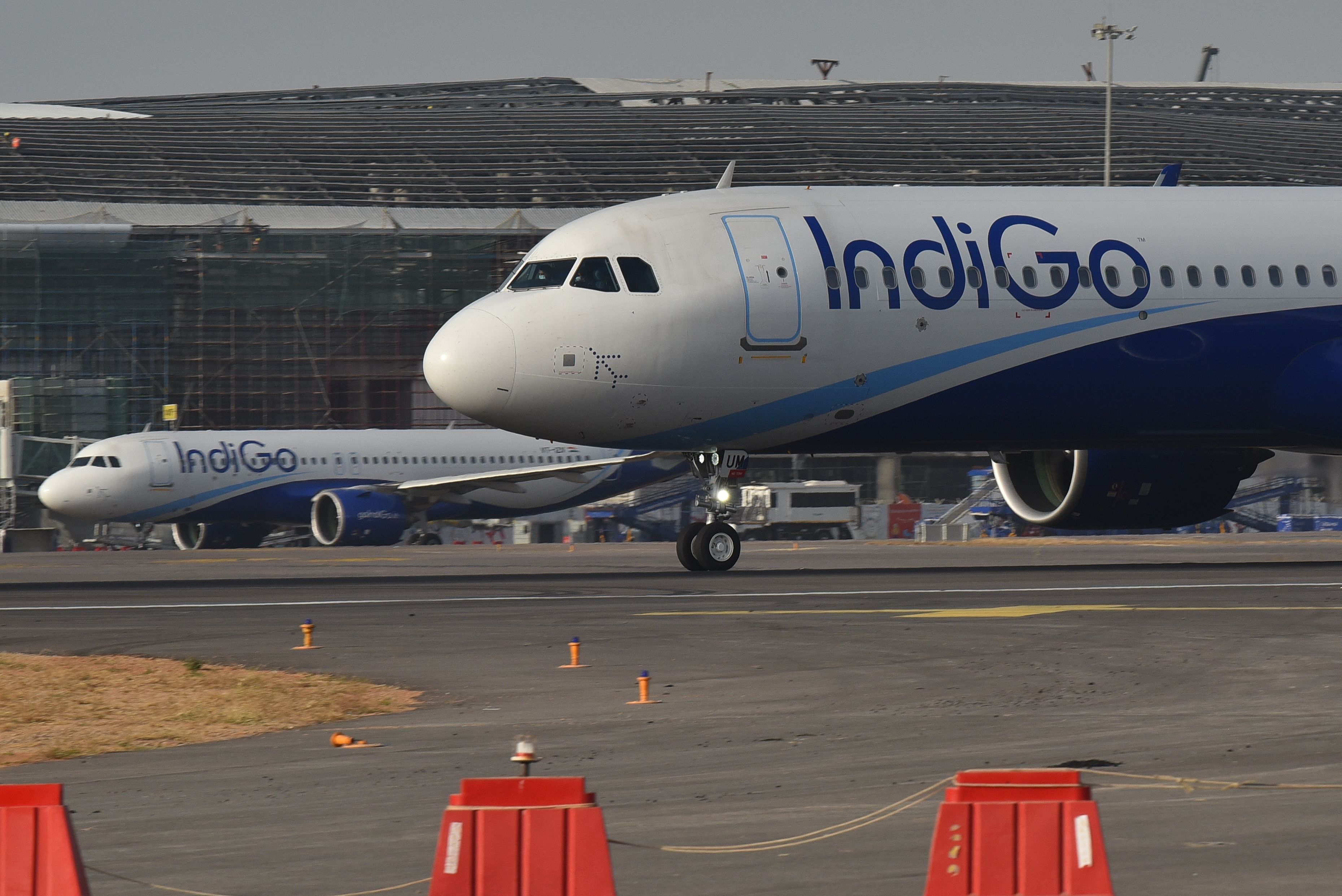 Multiple IndiGo A320s parked at Hyderabad Airport .