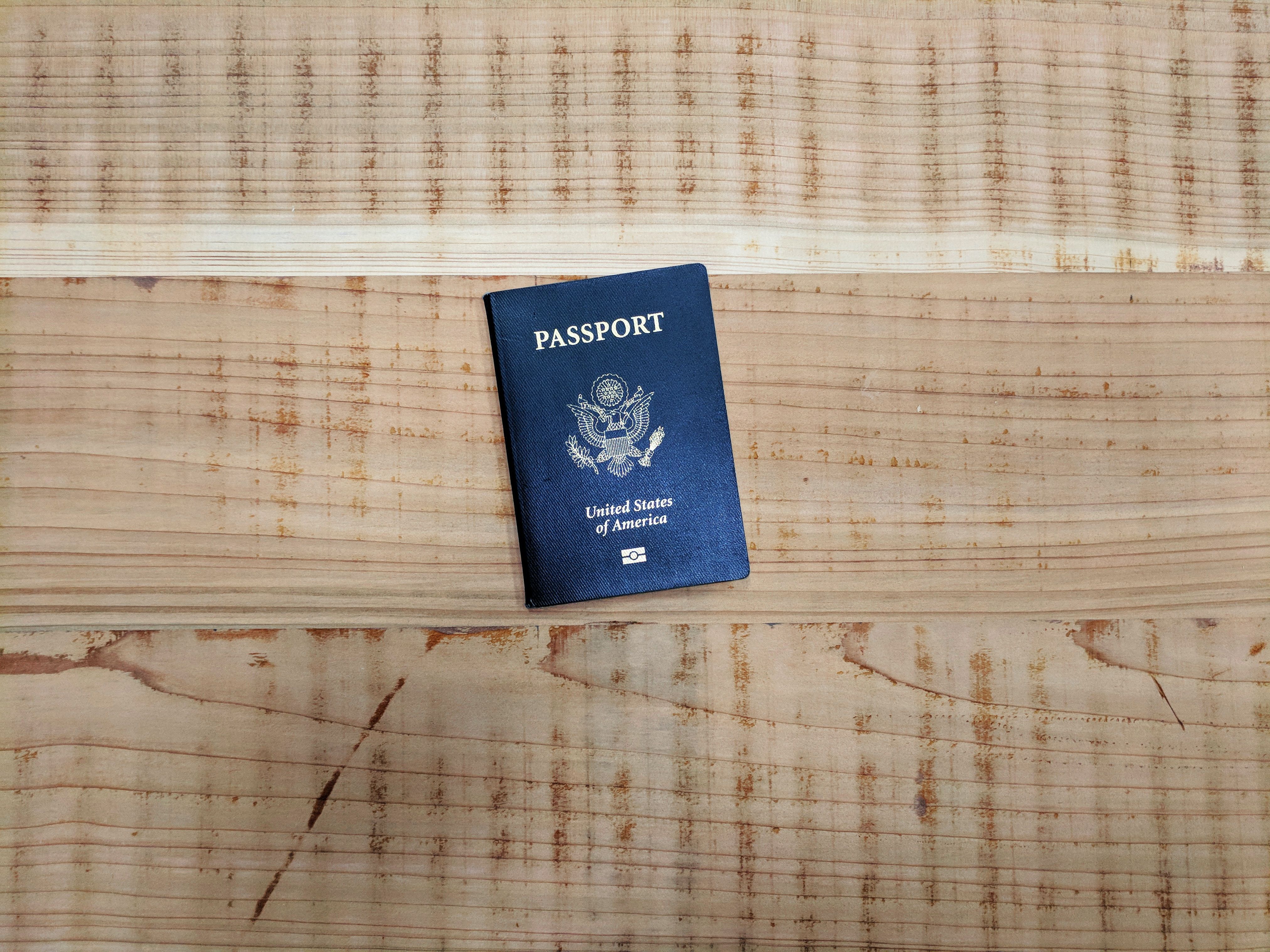 Blue passport on a wooden floor 