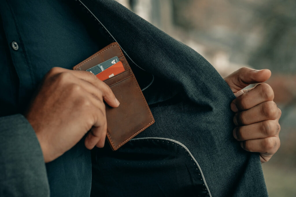 man putting a card wallet into his jacket pocket