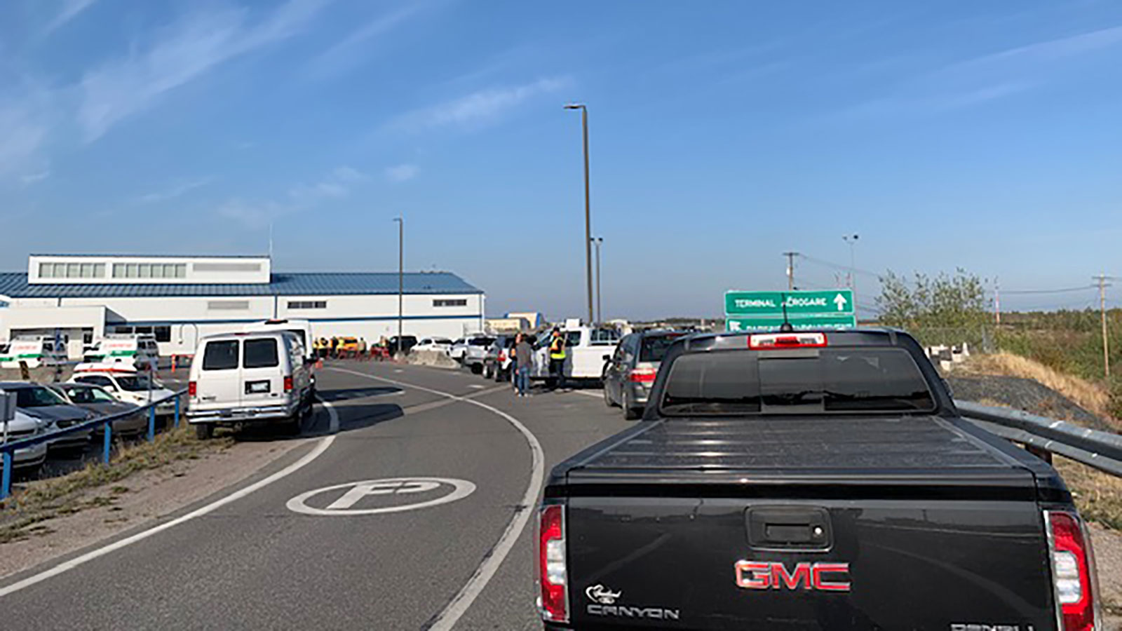 Vehicles line up to collect re-entry flight passengers in Yellowknife. Photo: Cathy Downes