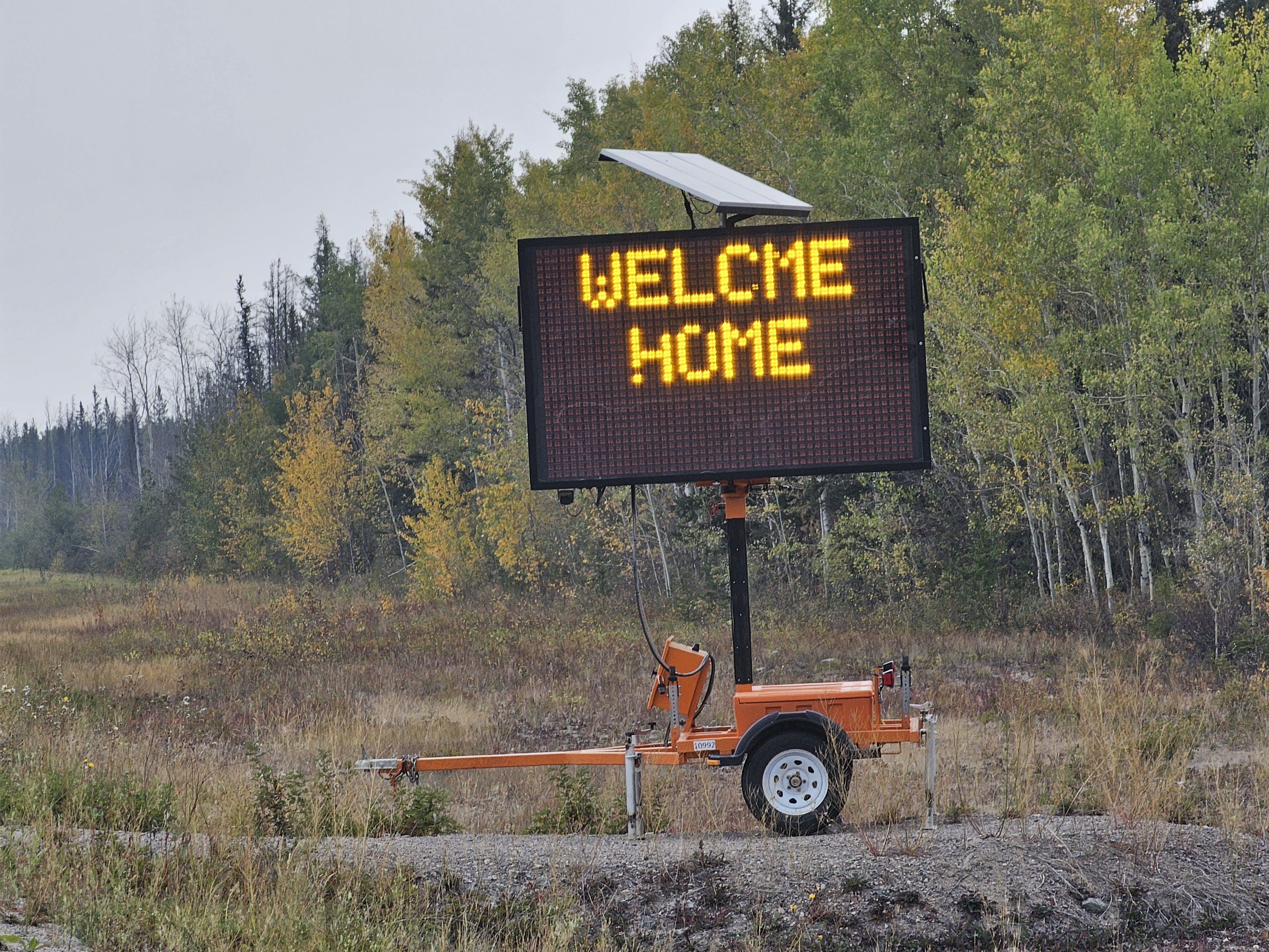 A sign reads "Welcme Home" alongside the highway north of Fort Providence. Ollie Williams/Cabin Radio