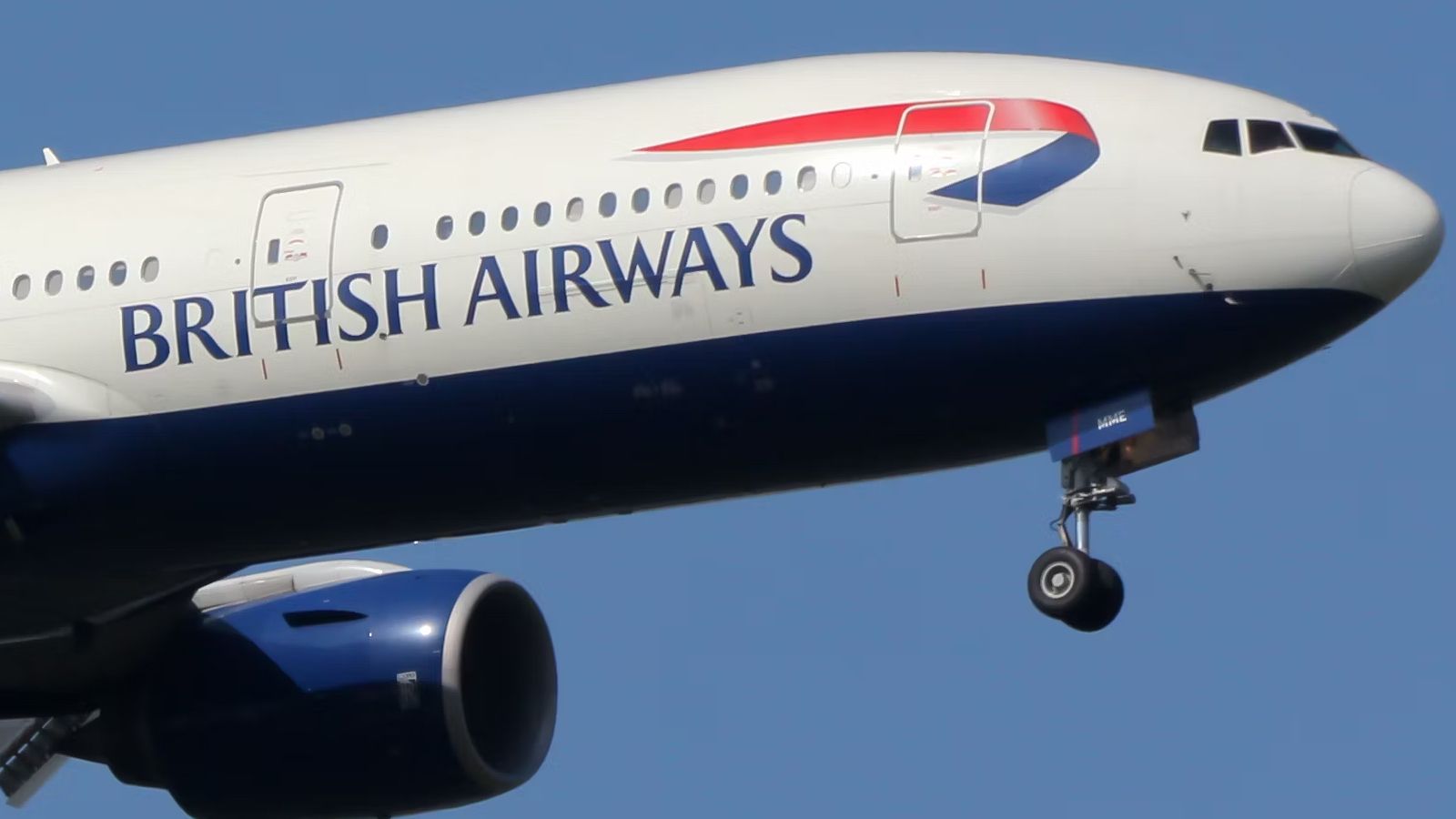 A Closeup of a British Airways Boeing 777-200 flying in the sky.