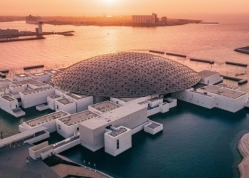 A landscape view of the Louvre Abu Dhabi Museum showcasing the iconic Rain of Light dome across the - Travel News, Insights & Resources.