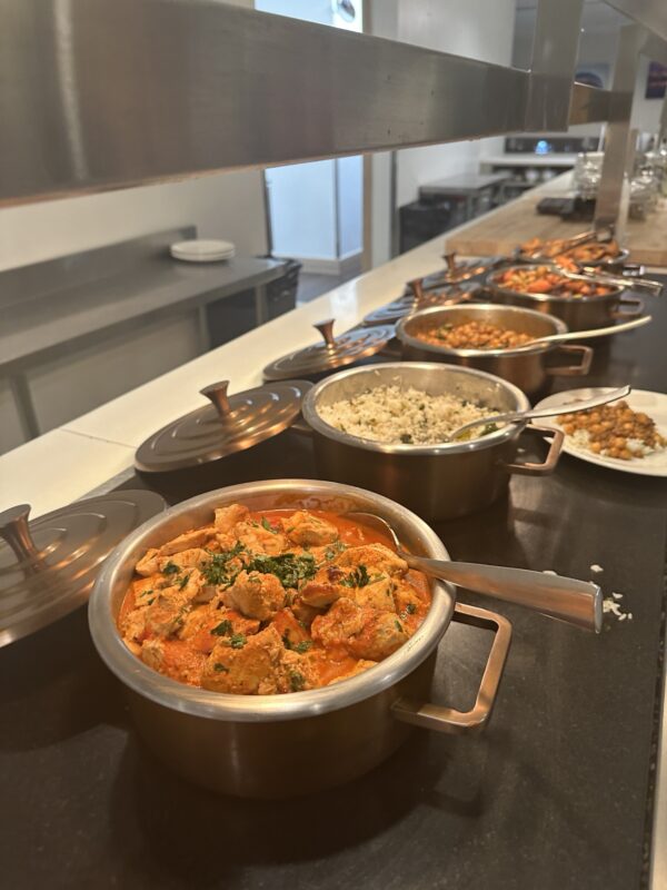 a group of pots of food on a counter