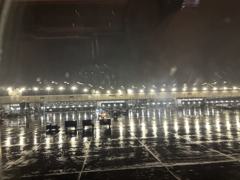 a wet floor with lights and chairs in the middle