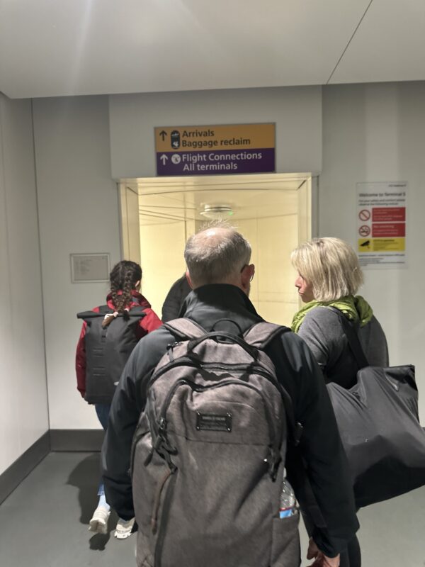 a group of people walking in an airport