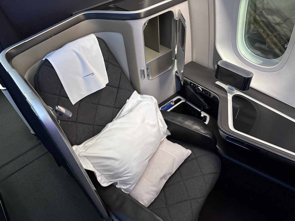 Overhead view of the grey BA suite with white linens sitting atop the seat.