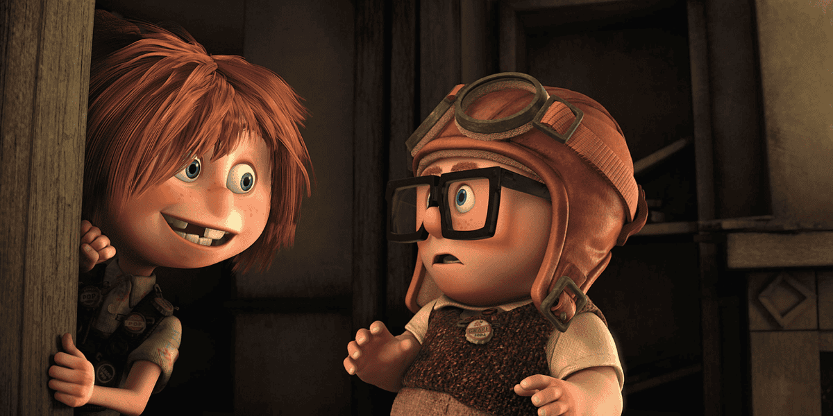 Two animated characters, a girl with orange hair and a boy in a helmet and glasses, peek around a corner with excited expressions in a dimly lit wooden environment.