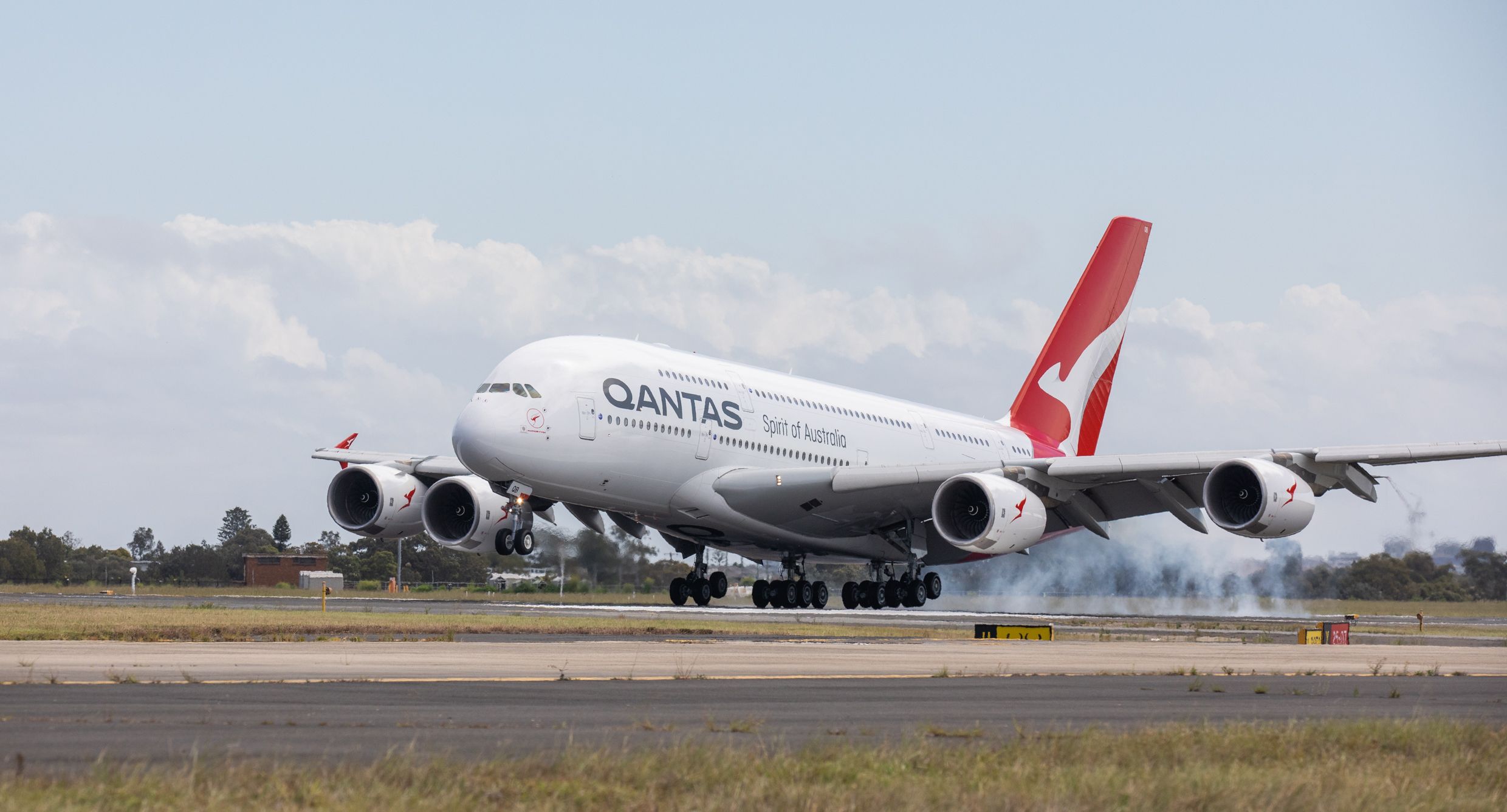 A Qantas Airbus A380 landing on a runway.